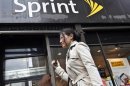 A woman walks past a Sprint store in New York's financial district
