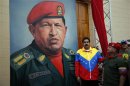 Venezuelan Vice President Nicolas Maduro and National Assembly President Diosdado Cabello stand next to a painting of Venezuelan President Hugo Chavez as they attend the commemoration of the 21st anniversary of Chavez's attempted cuop d'etat in Caracas