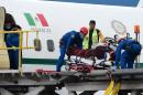 One of the six Mexican tourists wounded in a military attack in Egypt is taken to hospital on a stretcher by rescuers at the presidential hangar at Mexico City's airport on September 18, 2015