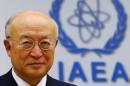 IAEA Director General Amano smiles as he waits for a board of governors meeting to begin at the IAEA headquarters in Vienna
