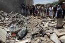 Yemenis gather near the rubble of houses near Sanaa Airport on March 31, 2015 which were destroyed by an air strike as Saudi-led coalition warplanes hit Shiite Huthi militia targets across Yemen overnight