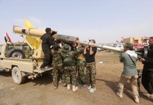 Iraqi paramilitary Shiite fighters load a locally made &hellip;