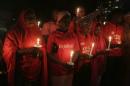People hold candles during a vigil to mark the one year anniversary of the abduction of girls studying at the Chibok government secondary school, Abuja, Nigeria, Tuesday, April 14, 2015. On the first anniversary of the day 276 schoolgirls were snatched in the middle of the night as they prepared to write science exams at their boarding school in northeastern Nigeria, President-elect Muhammadu Buhari said he cannot promise to find the 219 who are still missing. (AP Photo/Sunday Alamba)