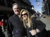 In this Friday, Feb. 1, 2013 photo, Sean and Leigh Anne Tuohy, adoptive parents of Baltimore Ravens starting offensive lineman Michael Oher, stand on a street in New Orleans. They were depicted in the move "The Blind Side" and will be attending Sunday's NFL football Super Bowl between the Ravens and the San Francisco 49ers. (AP Photo/Gerald Herbert)