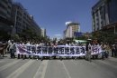 Demonstrators hold banner as they march on a street during a protest against a planned refinery which was believed to produce the chemical paraxylene (PX), near the Yunnan provincial government in Kunming