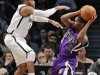 Brooklyn Nets C.J. Watson tries to block Sacramento Kings Aaron Brooks in their NBA basketball game in New York