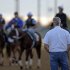 Trainer Todd Pletcher watches horses during a morning workout at Churchill Downs Thursday, May 2, 2013, in Louisville, Ky. (AP Photo/Charlie Riedel)