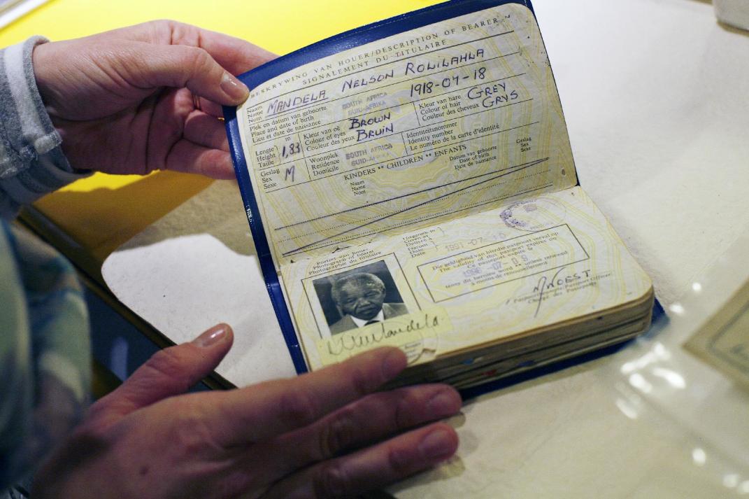 In this image taken Friday June 14, 2013, A Mandela Foundation employee shows the archived passport of former South African President Nelson Mandela. Nelson Mandela&rsquo;s condition in a Pretoria hospital remained critical for a second straight day Monday June 24, 2013, said South Africa&rsquo;s president Jacob Zuma, who described the stricken anti-apartheid hero as being &ldquo;asleep&rdquo; when he visited him the previous evening.(AP Photo/Jerome Delay)