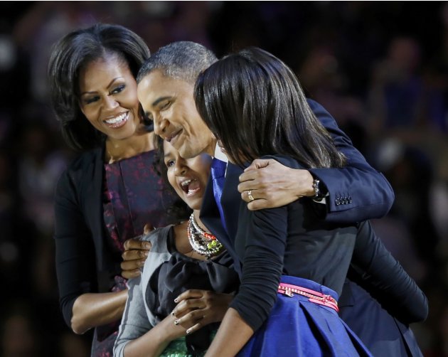 President Obama hugs daughters at victory rally in Chicago