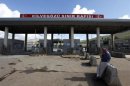 A man waits in front of the closed Cilvegozu border gate near the town of Reyhanli on the Turkish-Syrian border in Hatay province