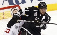 Los Angeles Kings' Anze Kopitar, of Slovenia, right, bumps New Jersey Devils' goalie Martin Brodeur in the first period during Game 4 of the NHL hockey Stanley Cup finals, Wednesday, June 6, 2012, in Los Angeles.  (AP Photo/Jae C. Hong)