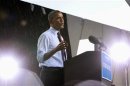 During a brief rainstorm, U.S. President Obama speaks at a campaign rally at the Henry Maier Festival in Milwaukee
