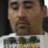 Jose Lopez, points to a undated photo of Riccardo Portillo, center, his brother-in-law, following a news conference Thursday, May 2, 2013, at Intermountain Medical Center, in Murray, Utah. A longtime Utah soccer referee is in a coma after being punched by a teenage player unhappy with one of his calls during a weekend game, and his family says they're hoping for the man's miraculous recovery and want justice for him. Ricardo Portillo, 46, has swelling in his brain and his recovery is uncertain as he remains in critical condition, Dr. Shawn Smith said Thursday at the Intermountain Medical Center in the Salt Lake City suburb of Murray. Police say a 17-year-old player in a recreational soccer league punched Portillo after the man called a foul on him and issued him a yellow card. The teen has been booked into juvenile detention on suspicion of aggravated assault. Those charges could be amplified if Portillo dies. (AP Photo/Rick Bowmer)
