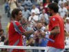 Ferrer of Spain is congratulated by Tipsarevic of Serbia after their men's singles quarterfinals match at the U.S. Open tennis tournament in New York