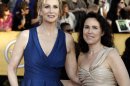 FILE - In this Jan. 29, 2012, file photo, Jane Lynch, left, and Lara Embry arrive at the 18th Annual Screen Actors Guild Awards in Los Angeles. Lynch is divorcing her wife of three years, Dr. Lara Embry, who she married in 2010 in Massachusetts. She told People magazine in a statement Monday, June 10, 2013, that splitting up was "a difficult decision for us as we care very deeply about one another." (AP Photo/Matt Sayles, File)