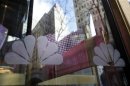 NBC logos are seen on a door with buildings around Rockefeller Center reflected in the background at the home of NBC's studios, in New York,