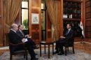 Syria's President Bashar al-Assad sits during an interview with journalists from Argentina in Damascus