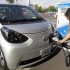 A participant to a press event by Toyota Motor Corp. puts a quick charger plug into the newly-developed compact electric vehicle "eQ" during a test drive at a press event in Tokyo Monday, Sept. 24, 2012. Toyota is boosting its green vehicle lineup, with plans for 21 new hybrids in the next three years, a new electric car later this year and a fuel cell vehicle by 2015 in response to growing demand for fuel efficient and environmentally friendly driving. (AP Photo/Koji Sasahara)