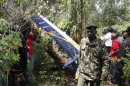 Kenyan officials inspect the area of the helicopter wreckage after it crashed in Ngong Forest, on the outskirts of Nairobi, Kenya, Sunday, June 10, 2012. Kenyan police say Sunday that cabinet minister George Saitoti, who once served as Kenya's vice president, was one of seven people killed in a helicopter crash on the outskirts of Nairobi. (AP Photo/Khalil Senosi)