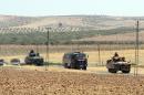 Turkish troops return from the Syrian border, in Karkamis, Turkey, Saturday, Aug. 27, 2016. Turkey on Wednesday sent tanks across the border to help Syrian rebels retake the key Islamic State-held town of Jarablus and to contain the expansion of Syria's Kurds in an area bordering Turkey.(Ismail Coskun, IHA via AP)