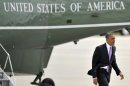 President Barack Obama walks off the Marine One helicopter before boarding Air Force One before leaving O'Hare International Airport in Chicago, Thursday, May 30, 2013. (AP Photo/Paul Beaty)
