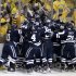 The Yale bench piles on right wing Andrew Miller to celebrate his game-winning overtime goal against UMass Lowell during an NCAA Frozen Four college hockey semifinal in Pittsburgh on Thursday, April 11, 2013. Yale won 3-2. (AP Photo/Gene J. Puskar)