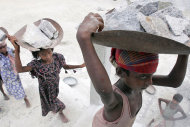 Child laborers carry stones on their head at a stone crusher on the eve of World Day against Child Labor, on the outskirts of Gauhati, India, Wednesday, June 11, 2008. (AP Photo/Anupam Nath)