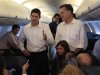 Republican U.S. presidential candidate Mitt Romney stands with his vice president selection U.S. Congressman Paul Ryan (R-WI) and granddaughter Chloe while speaking to the press aboard a charter flight to Charlotte, North Carolina from Dulles Airport