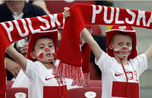Young Polish fans cheer before the start of their Group A Euro 2012 soccer match against Greece at the National Stadium in Warsaw