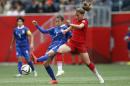 Germany's Melanie Leupolz, right, and Thailand's Silawan Intamee (7) vie for the ball during the first half of a FIFA Women's World Cup soccer game in Winnipeg, Manitoba, Canada, Monday, June 15, 2015. (John Woods/The Canadian Press via AP) MANDATORY CREDIT