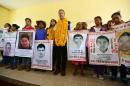 The representative for Mexico of the UN High Commissioner for Human Rights, Jan Jarab (C) poses with family members and relatives of missing students after a meeting at the Raul Isidro Burgos rural school in Ayotzinapa, Guerrero state, Mexico