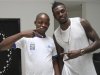Tottenham Hotspur's Emmanuel Adebayor (R) poses with a fan after an interview with journalists in Togo's capital Lome