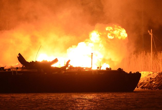 A massive explosion at 3a.m. EDT on one of the two barges still ablaze in the Mobile River in Mobile, Ala., on Thursday, April 25, 2013. Three people were injured in the blast. Fire officials have pulled units back from fighting the fire due to the explosions and no immediate threat to lives. (AP Photo John David Mercer) Three people were hospitalized with burns. Information on their conditions was not immediately available.