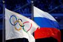 Russian national flag and Olympic flag are seen during closing ceremony for 2014 Sochi Winter Olympics