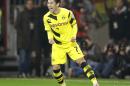 Dortmund's Shinji Kagawa from Japan celebrates after scoring his side's 3rd goal during the German soccer cup second round match between FC St. Pauli and Borussia Dortmund at the Millerntor Stadium in Hamburg, Germany, Tuesday, Oct. 28, 2014. (AP Photo/Michael Sohn)