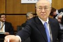 International Atomic Energy Agency IAEA Director General Amano reaches for paper before an IAEA meeting in Vienna