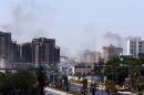 Smoke billows from the site of clashes on the road leading to the airport in the Libyan capital Tripoli on July 20, 2014