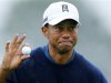 U.S. golfer Tiger Woods holds up his ball after making birdie to end his round 11-under par during second round play at the Farmers Insurance Open in San Diego