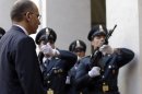 Italian Premier Enrico Letta reviews the honor guard as he arrives at Chigi palace Premier's office, in Rome, Sunday, April 28, 2013. Two Italian paramilitary police officers were shot and wounded Sunday in a crowded square outside the premier's office in Rome as Italy's new leader and his Cabinet were being sworn in a kilometer (half-mile) away. It was unclear if there was any connection between the events. (AP Photo/Gregorio Borgia)