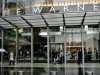 People walk in front of the Time Warner Inc. headquarters building at Columbus Circle in New York Oc..