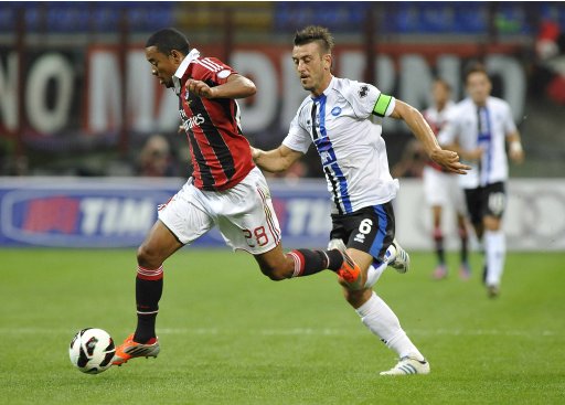 AC Milan's Robinho is challenged by Atalanta's Bellini during their Serie A soccer match at the San Siro stadium in Milan