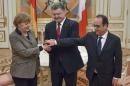 Ukraine's President Poroshenko shakes hands with German Chancellor Merkel and French President Hollande during their meeting in Kiev