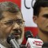 Muslim Brotherhood's presidential candidate Mohamed Morsy addresses a news conference in Cairo