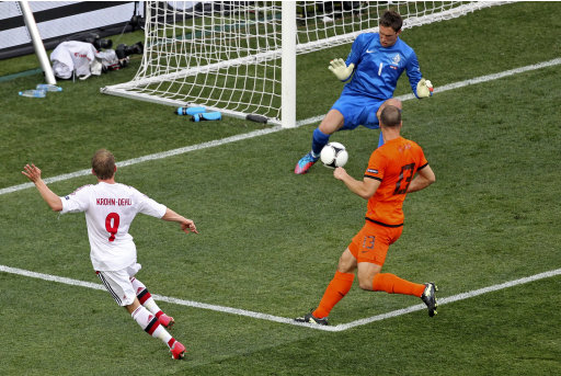 Denmark's Michael Krohn-Dehli, left, scores during the Euro 2012 soccer championship Group B match between the Netherlands and Denmark in Kharkiv, Ukraine, Saturday, June 9, 2012. (AP Photo/Michael Probst)