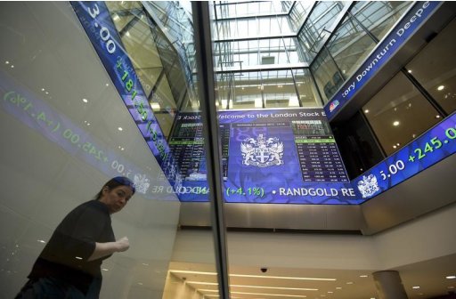 Electronic information boards display market information at the London Stock Exchange in the City of London
