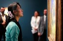 Aung San Suu Kyi looks a Van Gogh painting as she visits the Orsay museum, in Paris