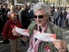 A Rolling Stones fan displays two tickets he purchased for a short warm-up gig in Paris