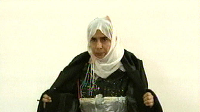 FILE  - This Nov. 13, 2005 file photo  made from television shows Iraqi Sajida al-Rishawi opens her jacket and shows an explosive belt as she confesses on Jordanian state-run television to her failed bid to set off an explosives belt  inside one of the three Amman hotels targeted by al-Qaida. Al-Rishawi, was sentenced to death. In January 2015, almost a decade later, she has emerged as a potential bargaining chip in negotiations over Japanese hostages held by the Islamic State group, the successor of al-Qaida in Iraq, which orchestrated the Jordan attack. (AP Photo/Jordanian TV, File)