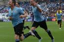 Uruguay's Cristian Rodriguez, left, celebrates with teammates after scoring during a Copa America Group B soccer match at the Calvo y Bascunan Regional Stadium in Antofagasta, Chile, Saturday, June 13, 2015. (AP Photo/ Luis Hidalgo)