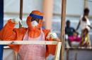 A health worker wearing protective gear works on November 11, 2014 in the red zone of the Hastings treatment centre, outside the Sierra Leone capital Freetown